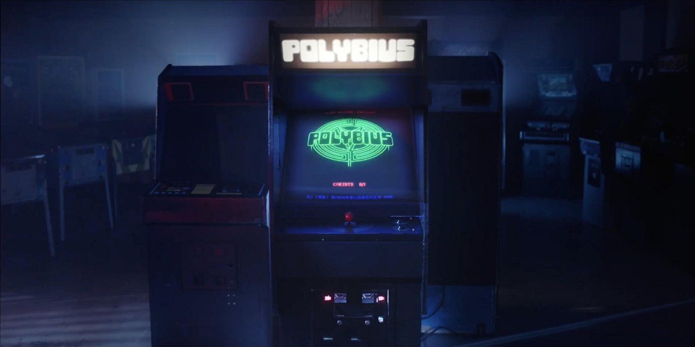 A lit up Polybius arcade game in a dim space.