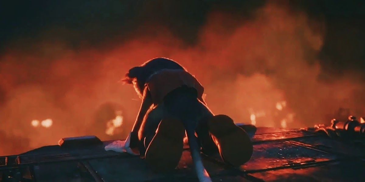 Final Fantasy VII remake Cait Sith on its knees as Midgar burns in the background