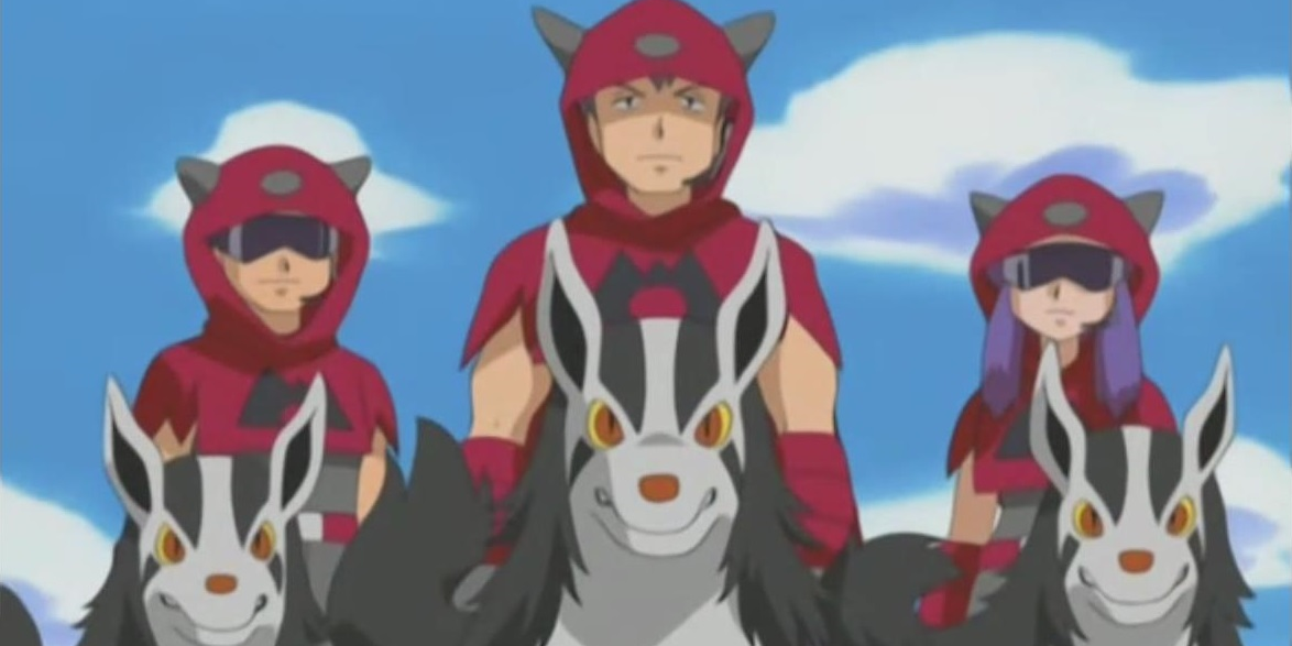 Three Team Magma members standing behind their Mightyena
