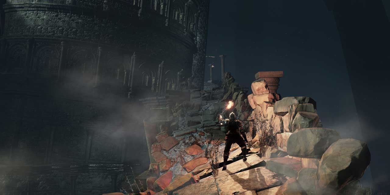 knight standing with torch on rocky ruins in dark cave