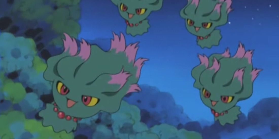 A swarm of Misdreavus happily floating through a forest in the Pokemon anime
