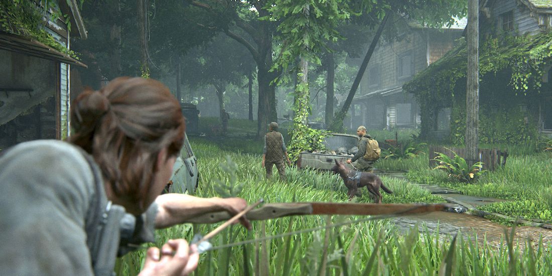 Ellie crouched in the grass as she aims an arrow at a dog with some WLF soldiers.
