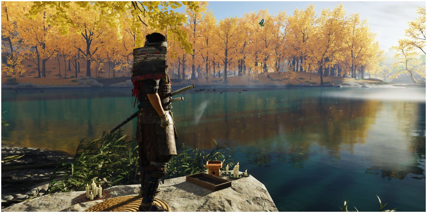 Jin Sakai standing next to gorgeous lake in Ghost of Tsushima