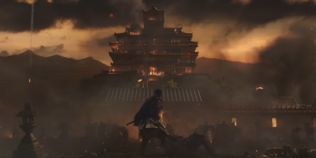 Jin standing before large building on fire