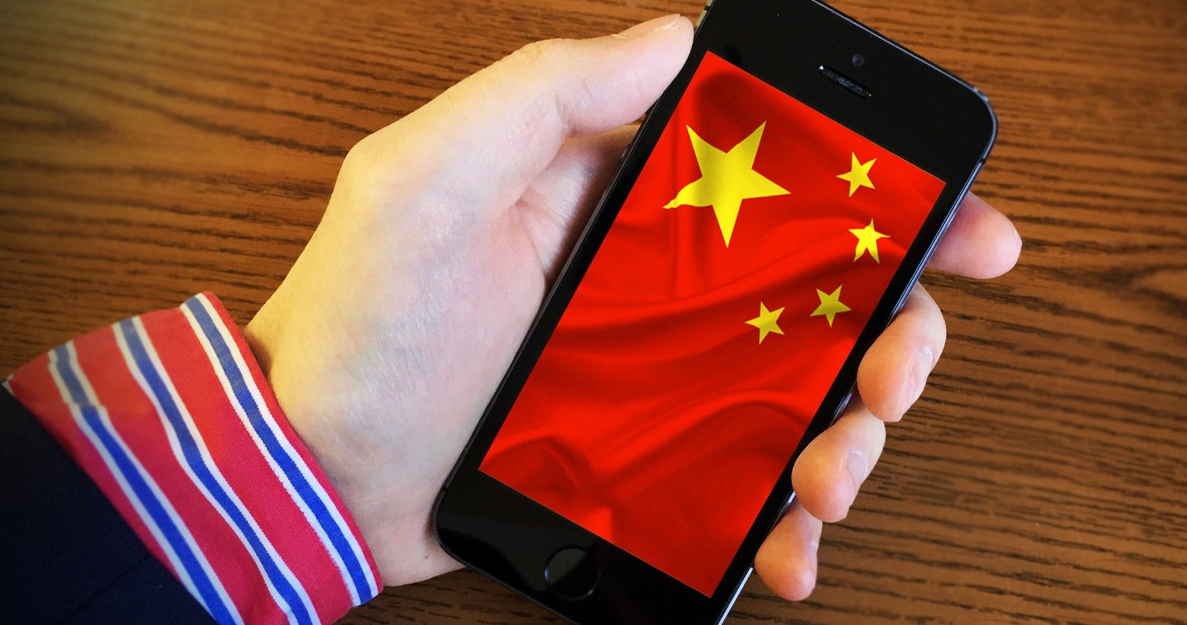 Holding Phone With Chinese Flag On Display