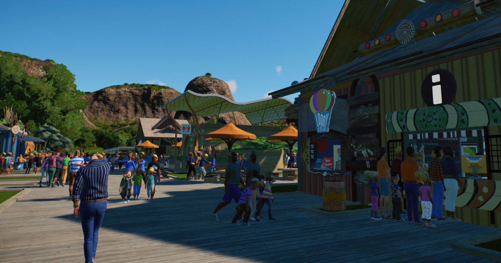 A main street in a zoo with stores and facilities along the edges.