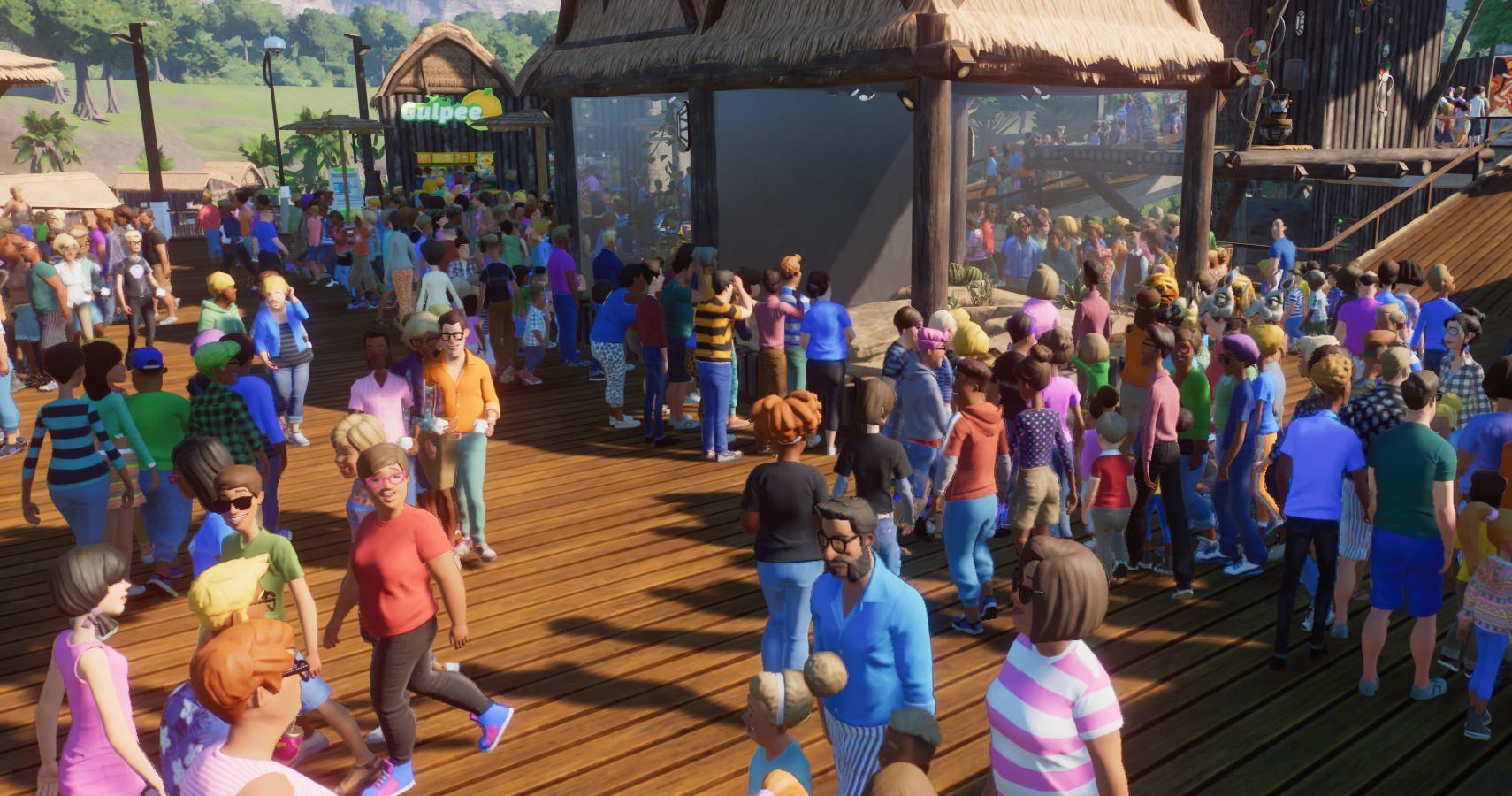A crowd in a zoo around a small animal exhibit.