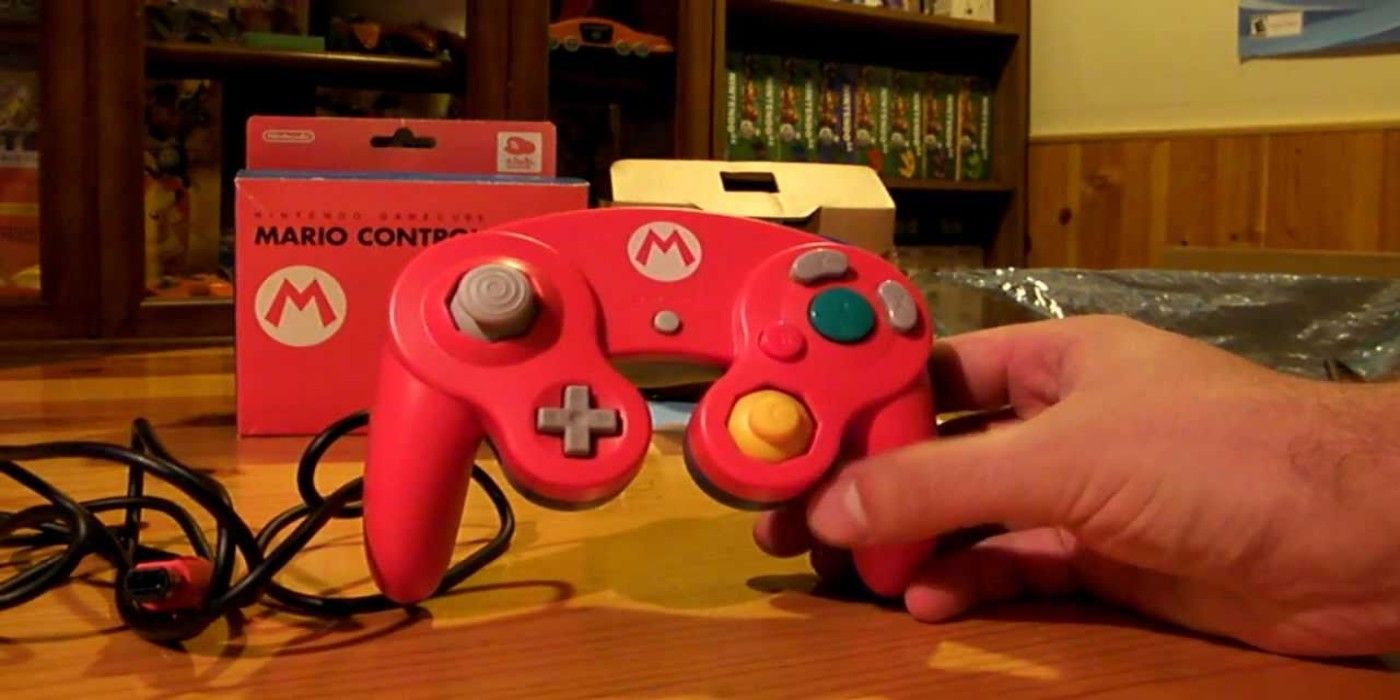 Holding a Mario themed GameCube controller