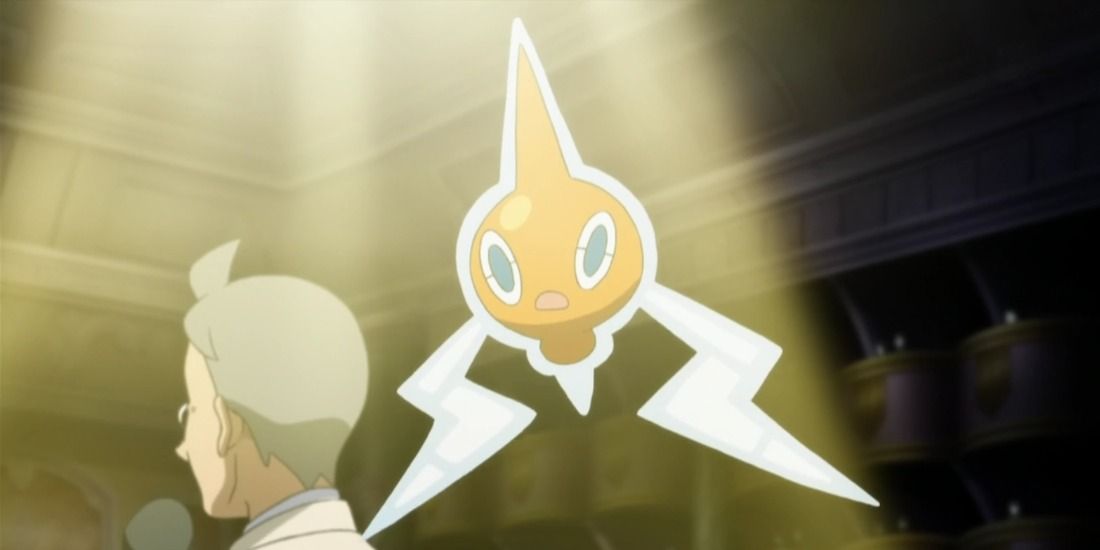 Rotom scared in a spotlight as a man talks in the Pokémon anime