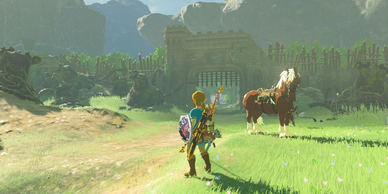 Link standing in front of Fort Hateno with Epona