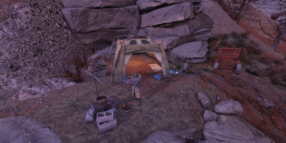 Cave entrance with player campning outside Fallout 76