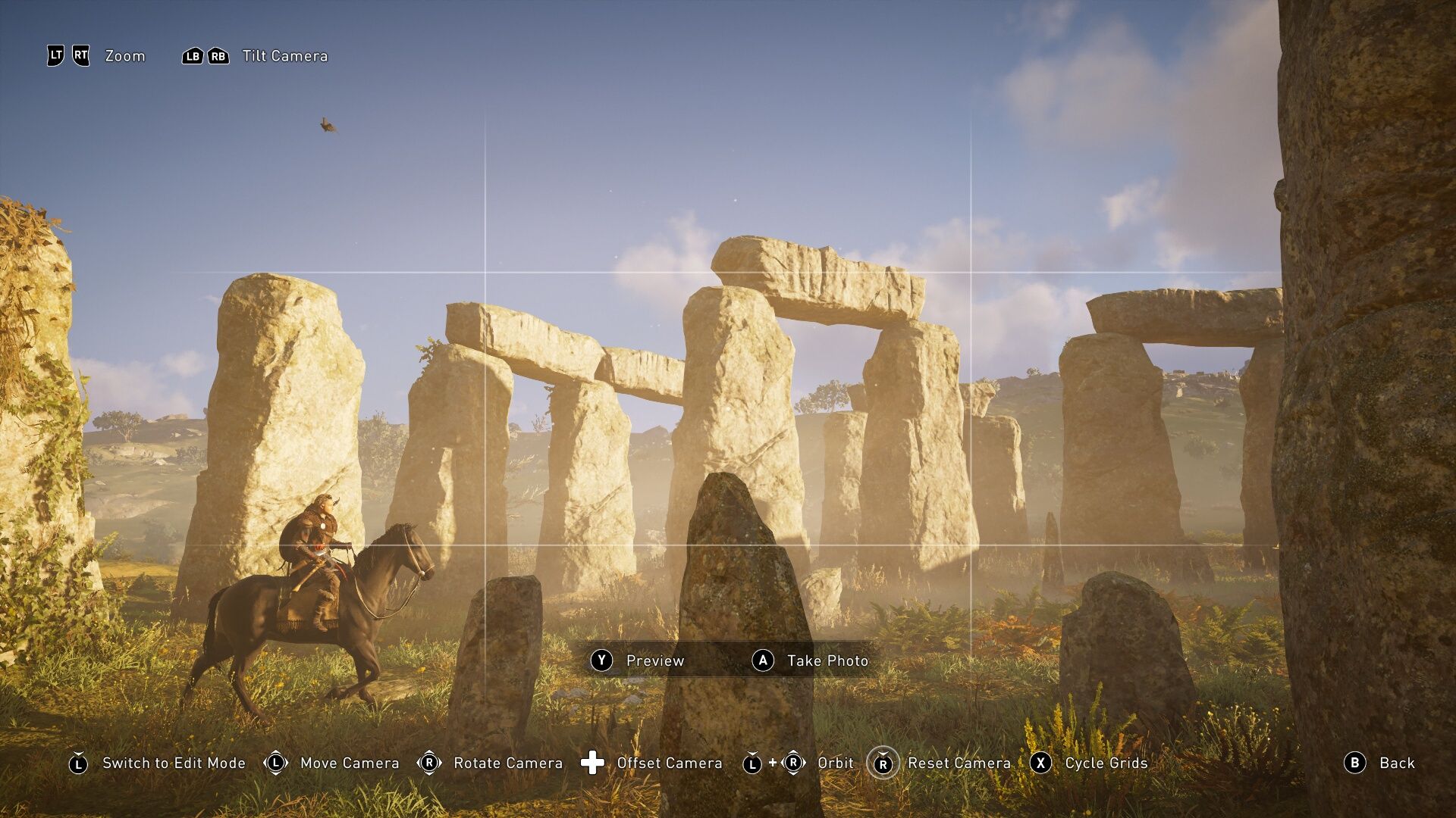A screenshot of Stonehenge in evening light, with the player character on a horse in the foreground.