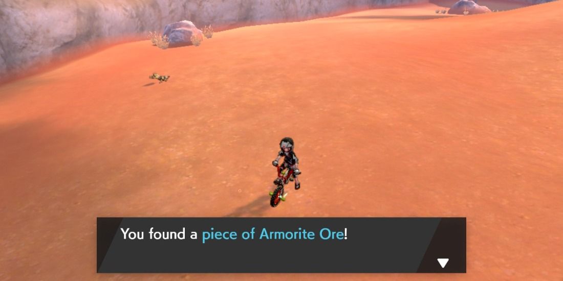 Armorite Ore being picked up on the floor of Potbottom Desert in in Pokemon Sword & Shield