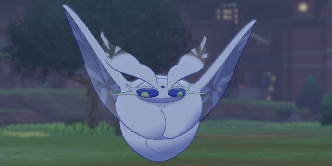 Frosmoth floating at night in the Wild Area from Pokemon Sword & Shield