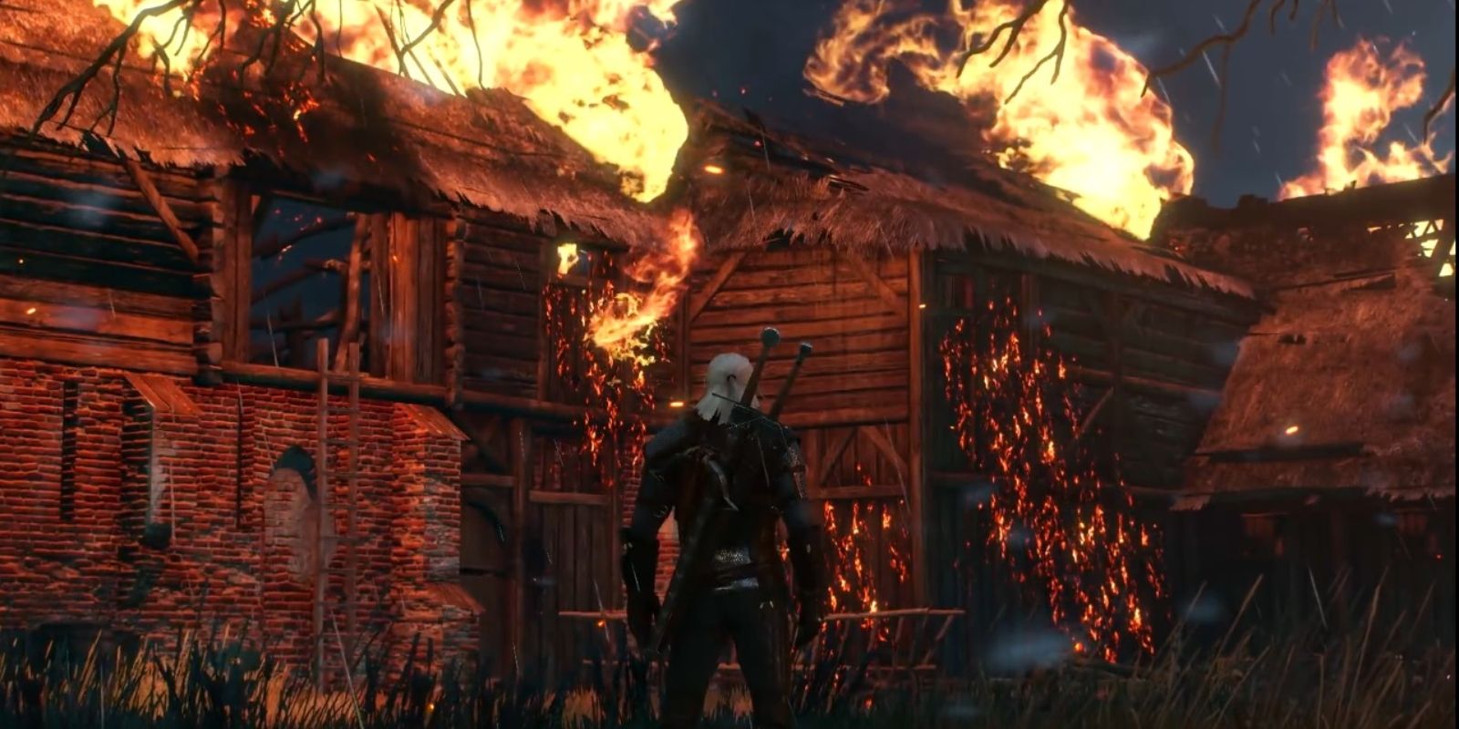 A building on fire while Geralt looks at it.