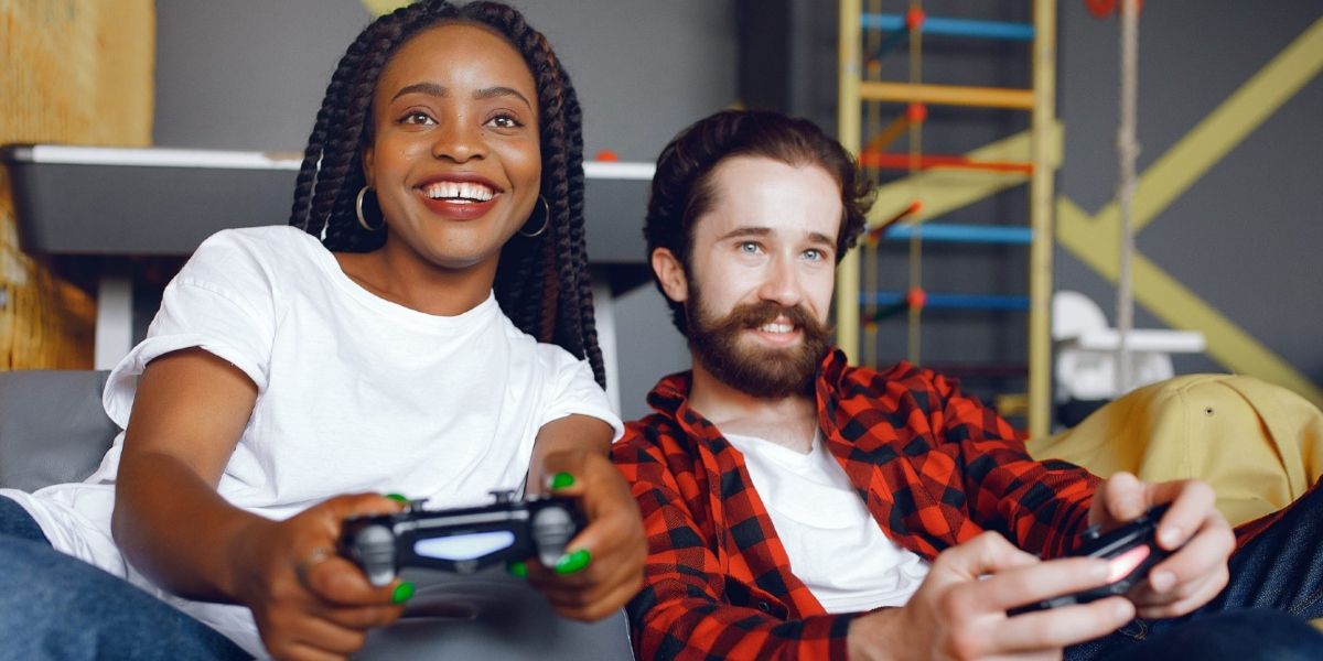 Two people playing PS4