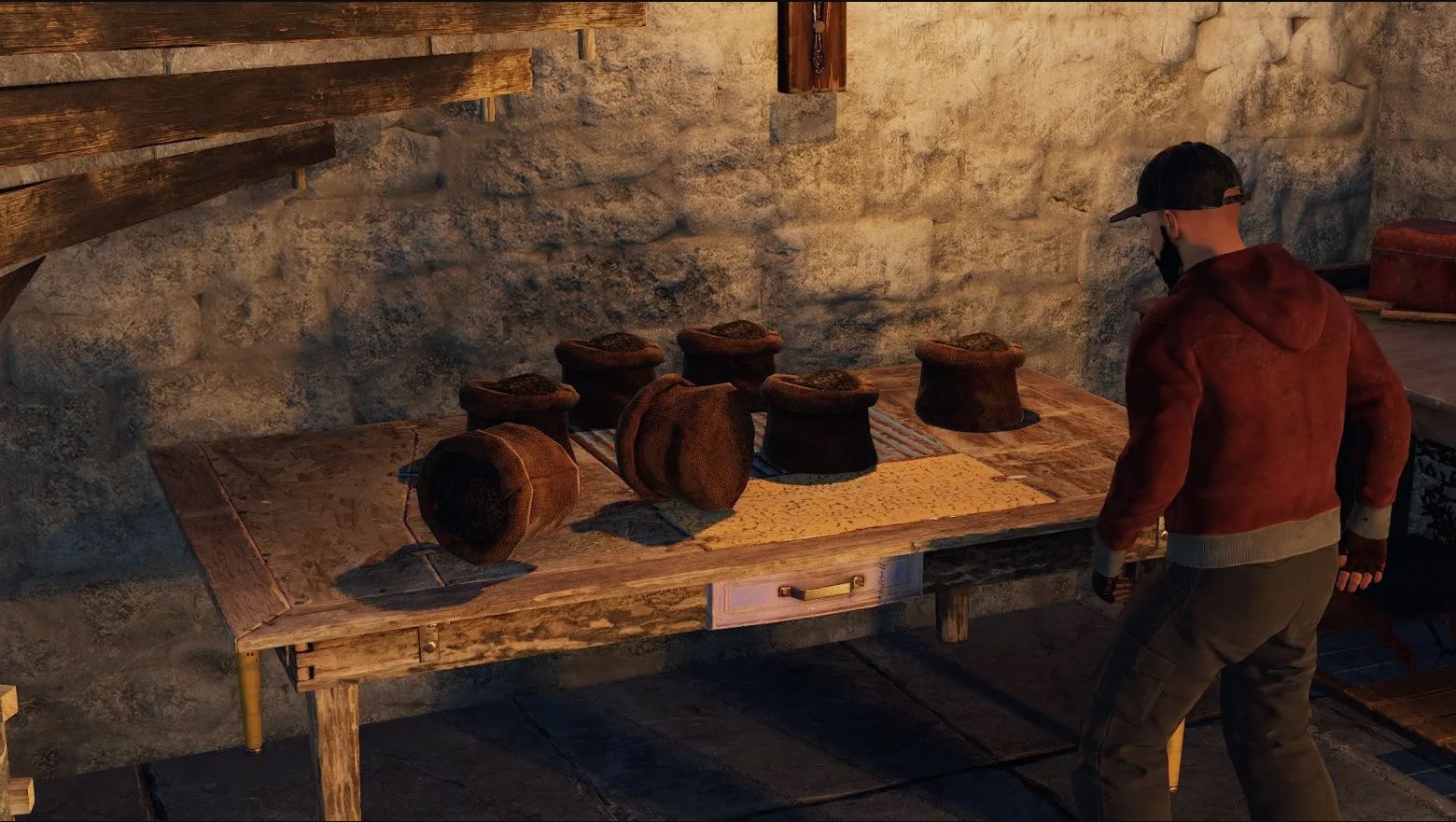 A man standing beside a table with gun power atop it in Rust.