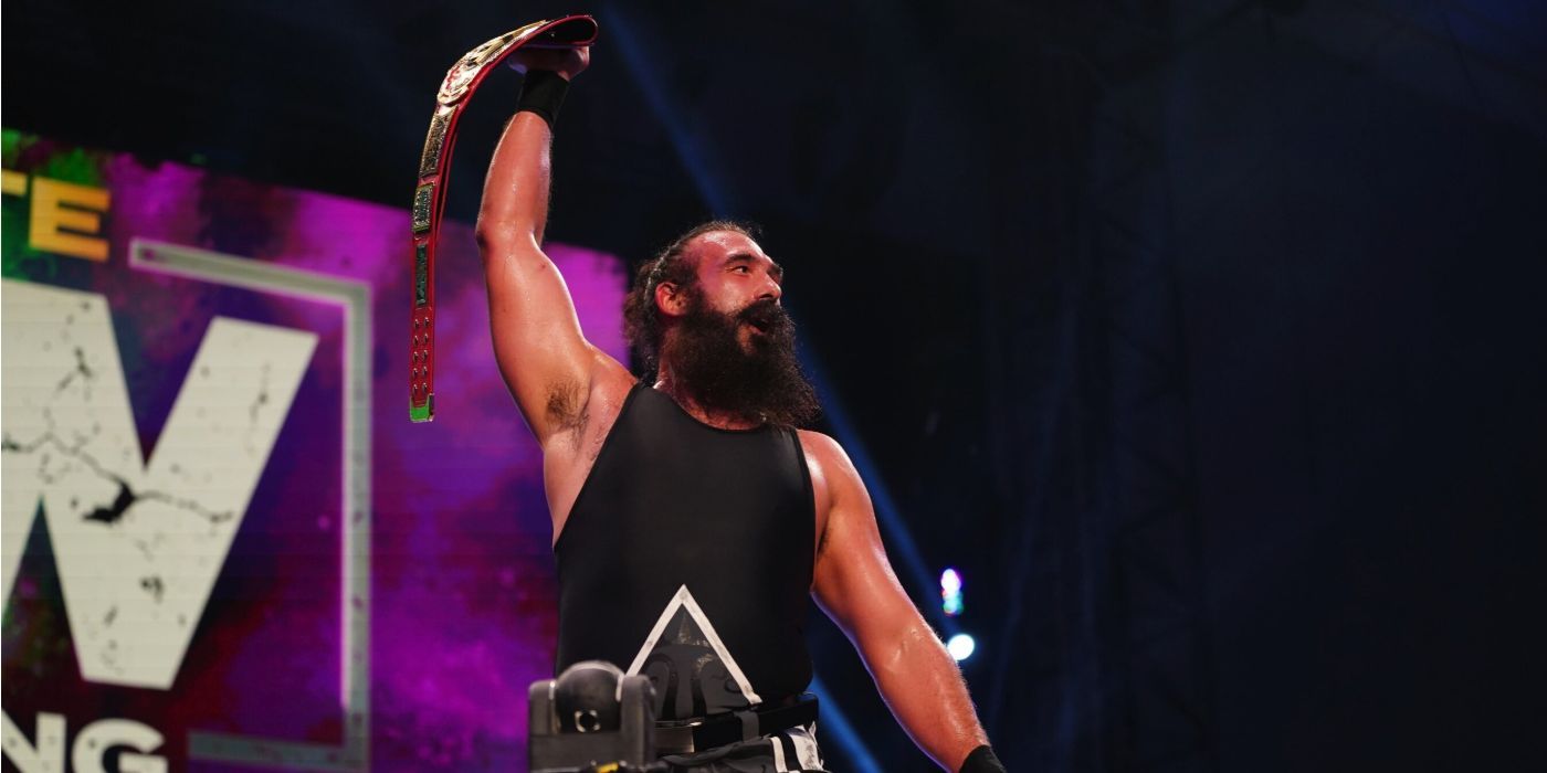 The late Brodie Lee holds up his TNT Championship belt in AEW