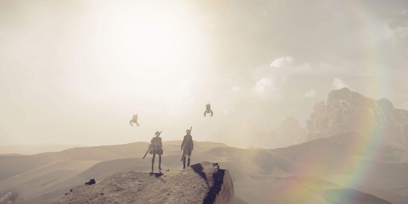 2B and 9S standing on a rock in the desert in Nier Automata