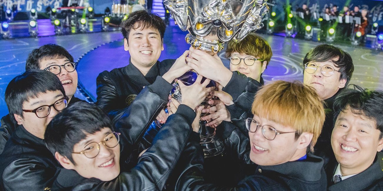 All members of Samsung Galaxy Together Holding Up Summoners Cup and Smiling