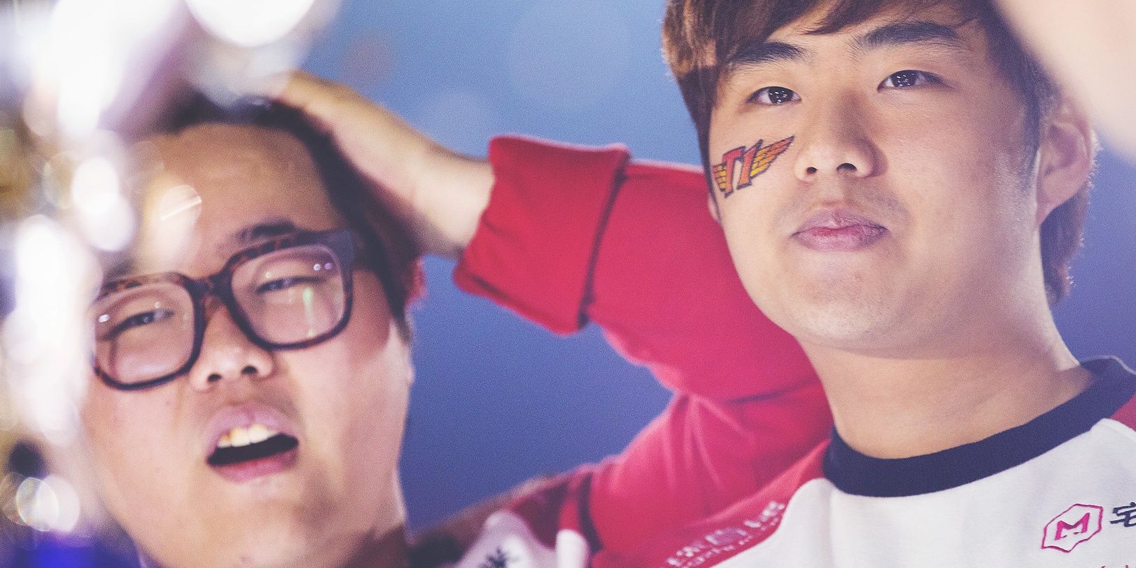 League Of Legends Bang and Wolf in disbelievement after winning world championship title looking at the trophy