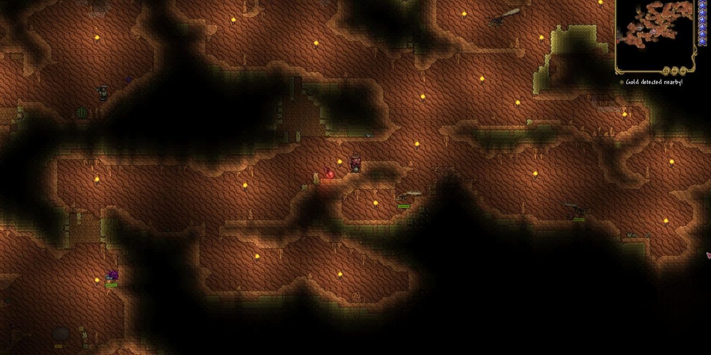 A Terraria player traverses the sandy desert caverns, dimly lit by torches, with large flying insects not too far ahead of them, and a bunch of smaller enemies following the player from the bottom left of the image.