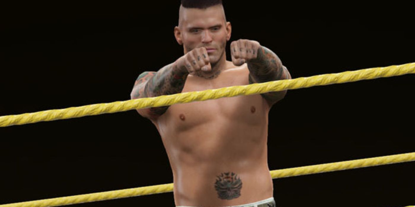 Corey Graves shows the crowd his tatted up knuckles while in the ring in WWE 2k15