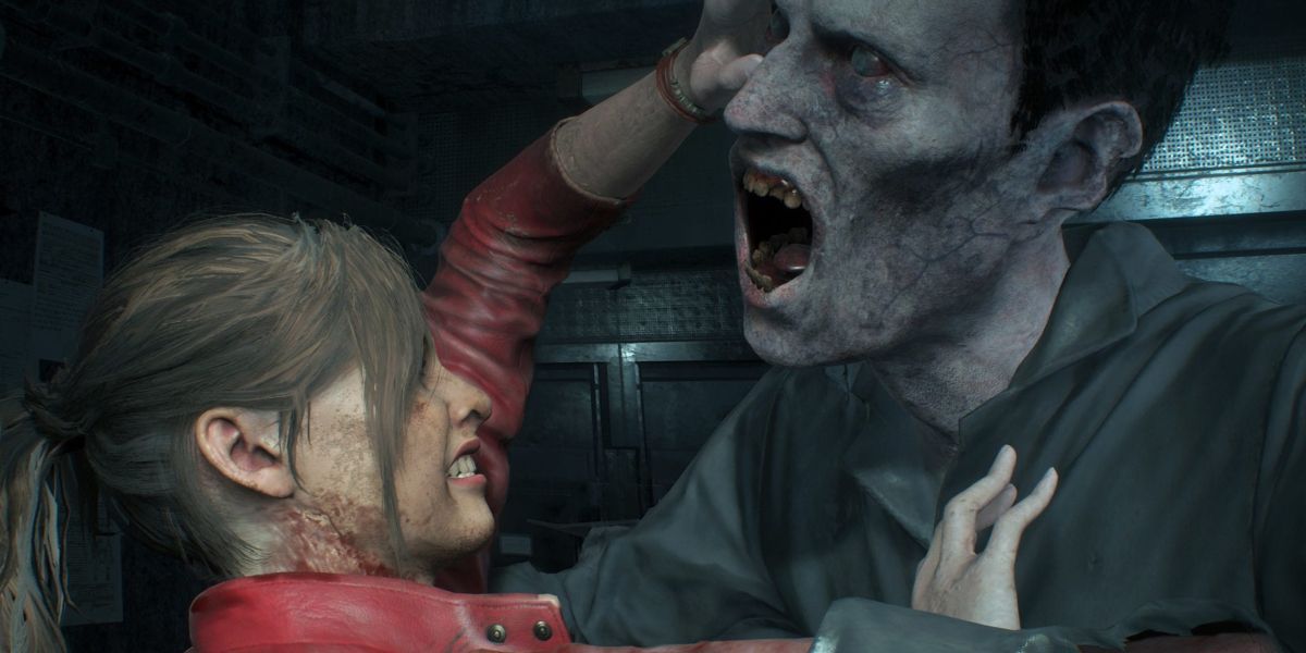 Claire Redfield grapples with a zombie trying to bite her.