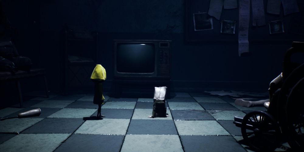 little nightmares 2 six and mono in front of a tv in the hospital