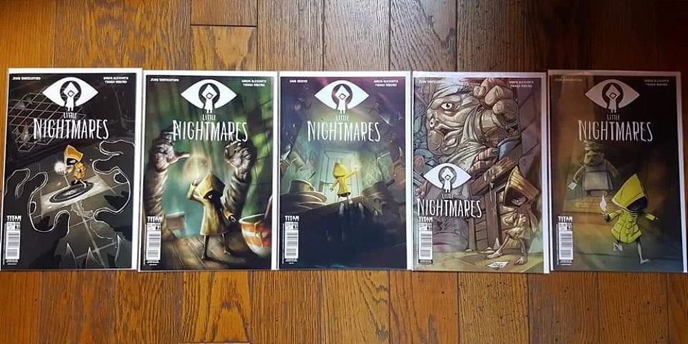 every issue of the physical little nightmares comics lined up on the floor