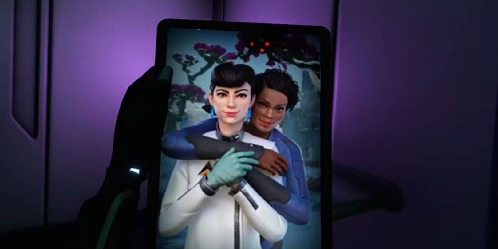 Robin holding a photo of Sam and Danielle together