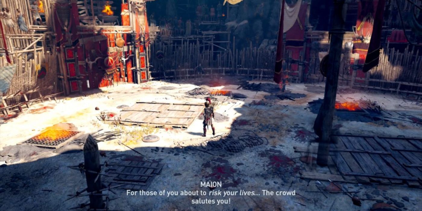 Kassandra stands in the arena as Maion (offscreen) hypes up both the crowd and competing warriors