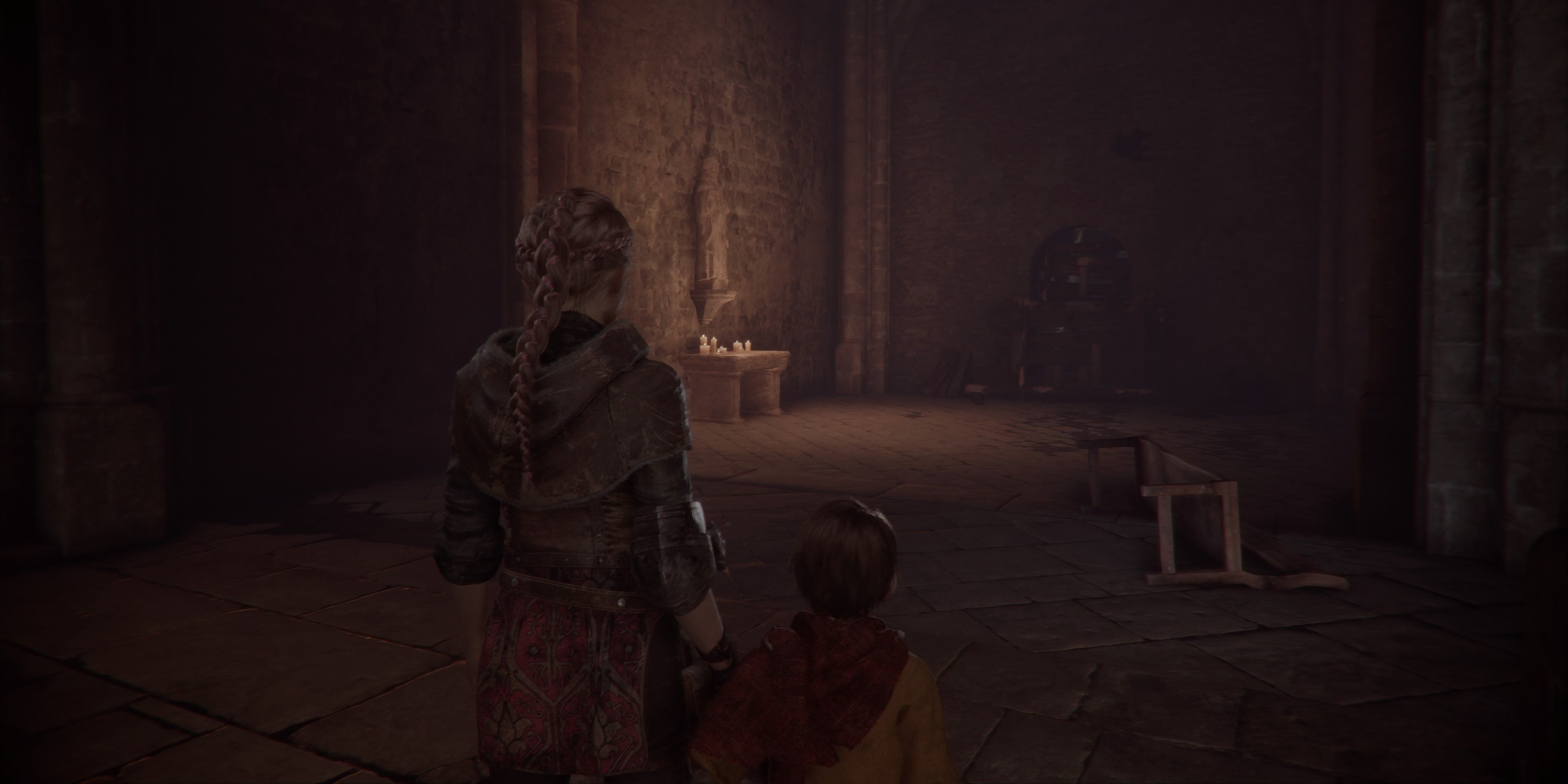 Rosiary located on a stone table with candles