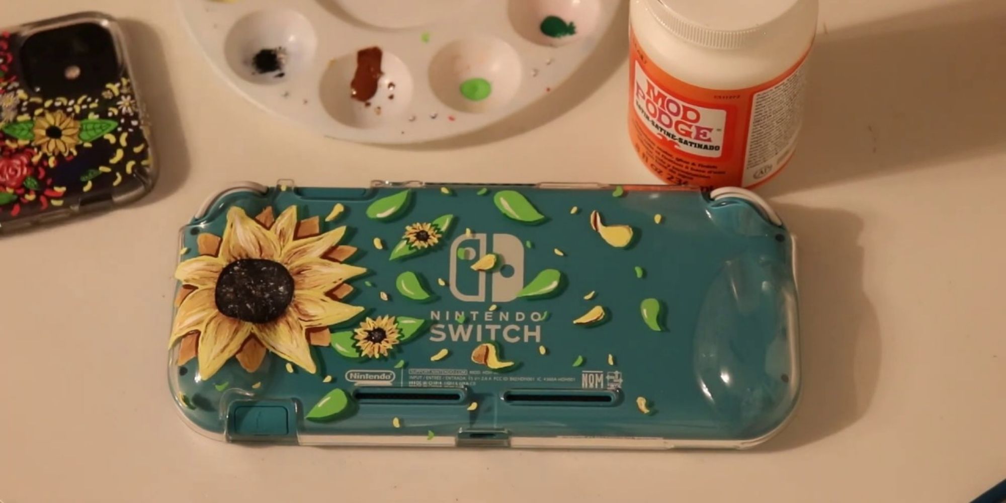 Hand-painted sunflower on a Nintendo Switch lite