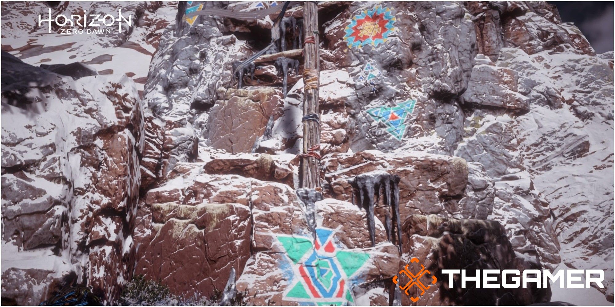 Cliff  with painted symbols and colored rope
