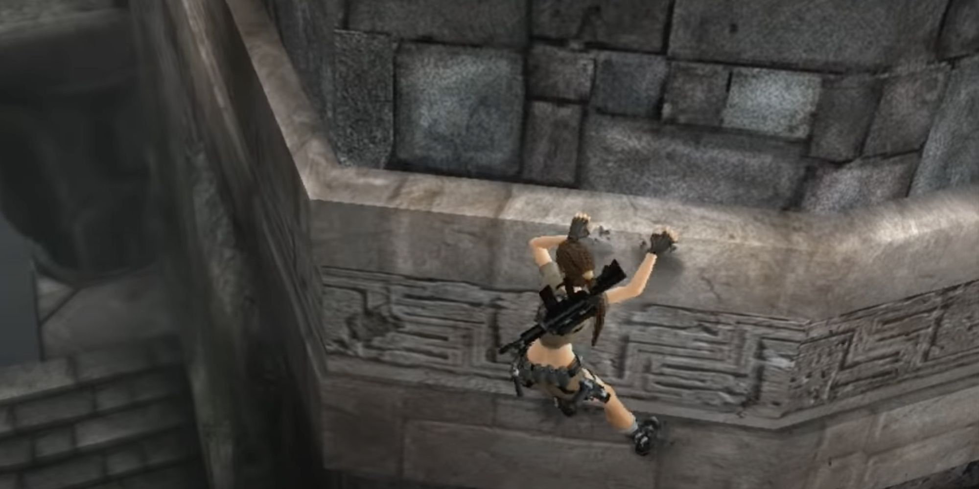 Lara traverses the cliffs along the side of the end chamber to make her way to the gold reward.
