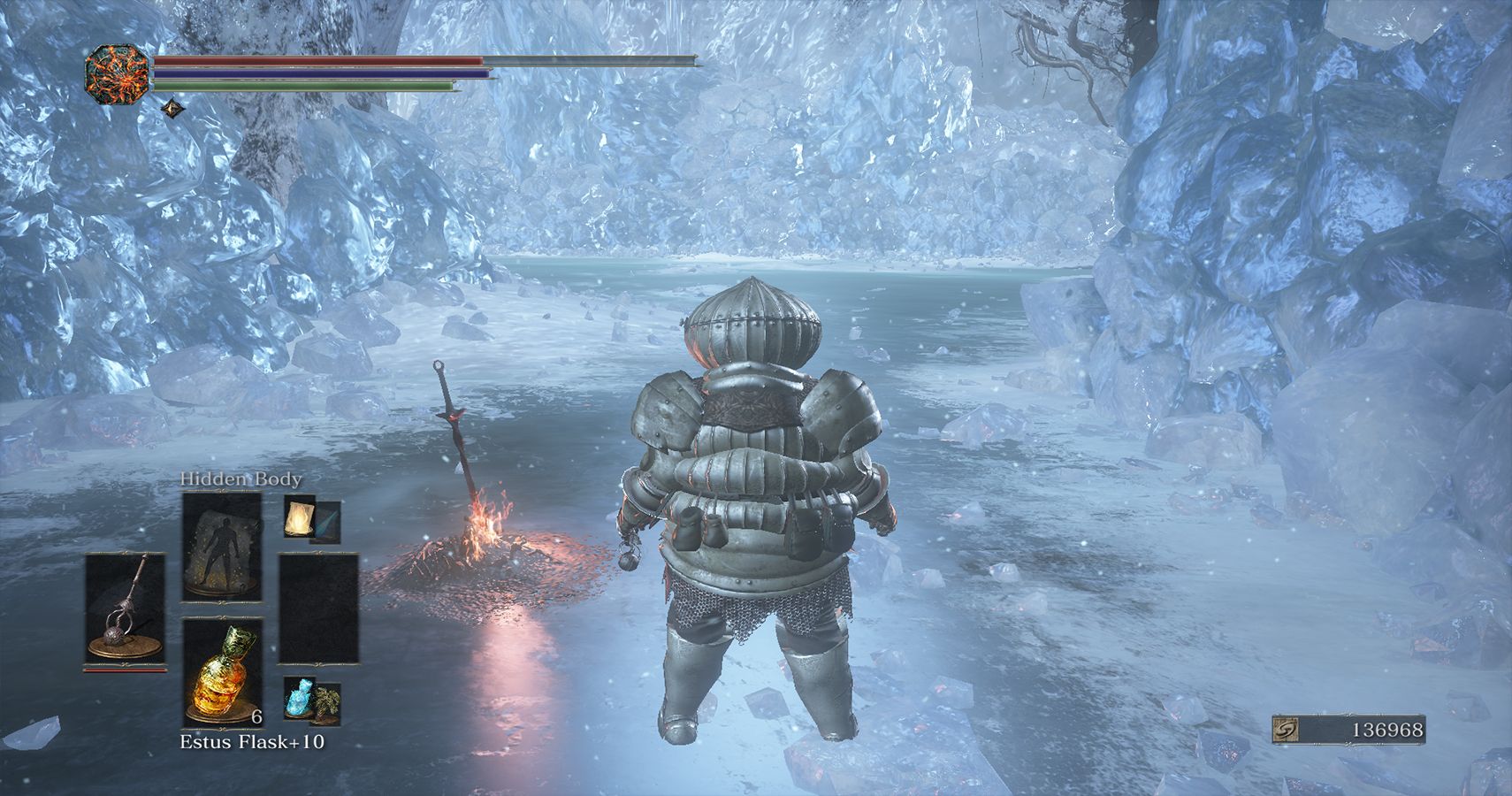player standing by bonfire on ice in a cavern