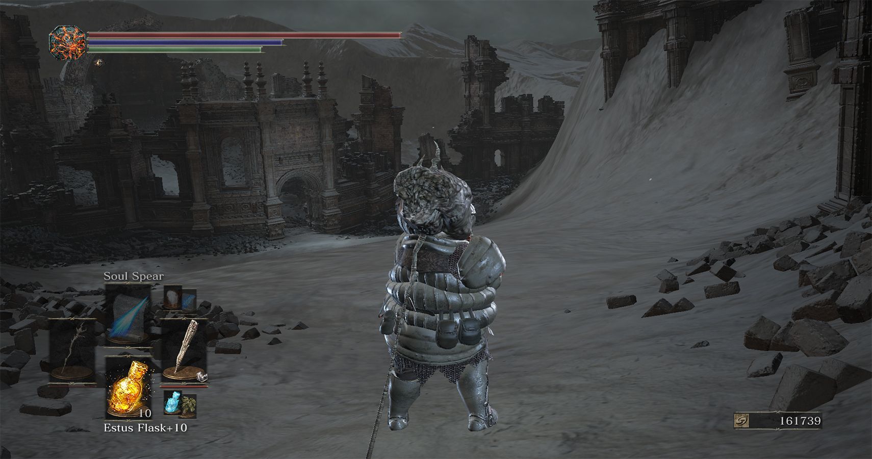 player standing in desert of ash near ruins of a church building
