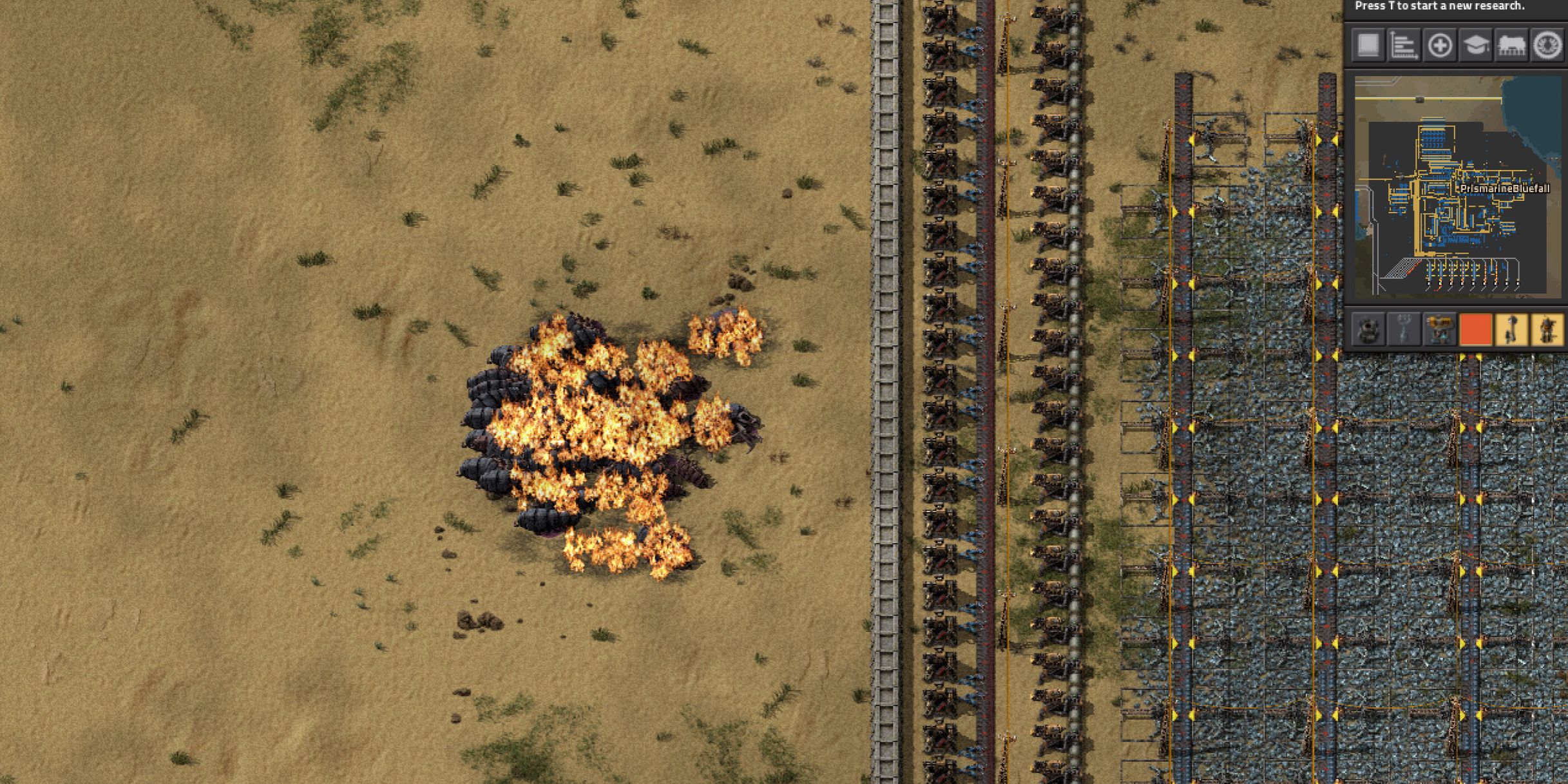 A horde of Biters attacking a base in Factorio.
