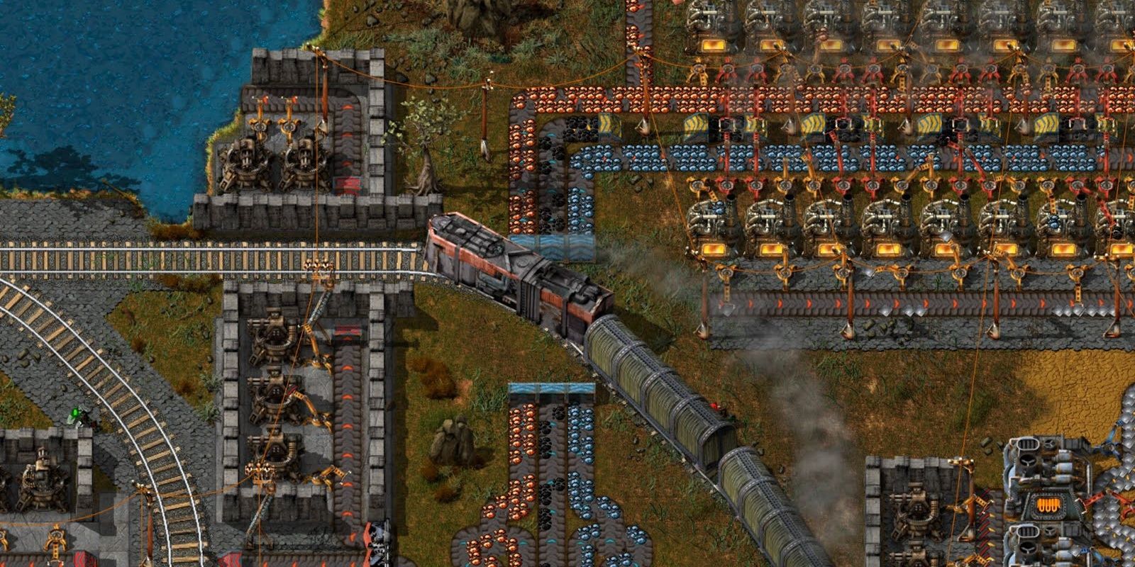 A train passing by a growing factory in Factorio.