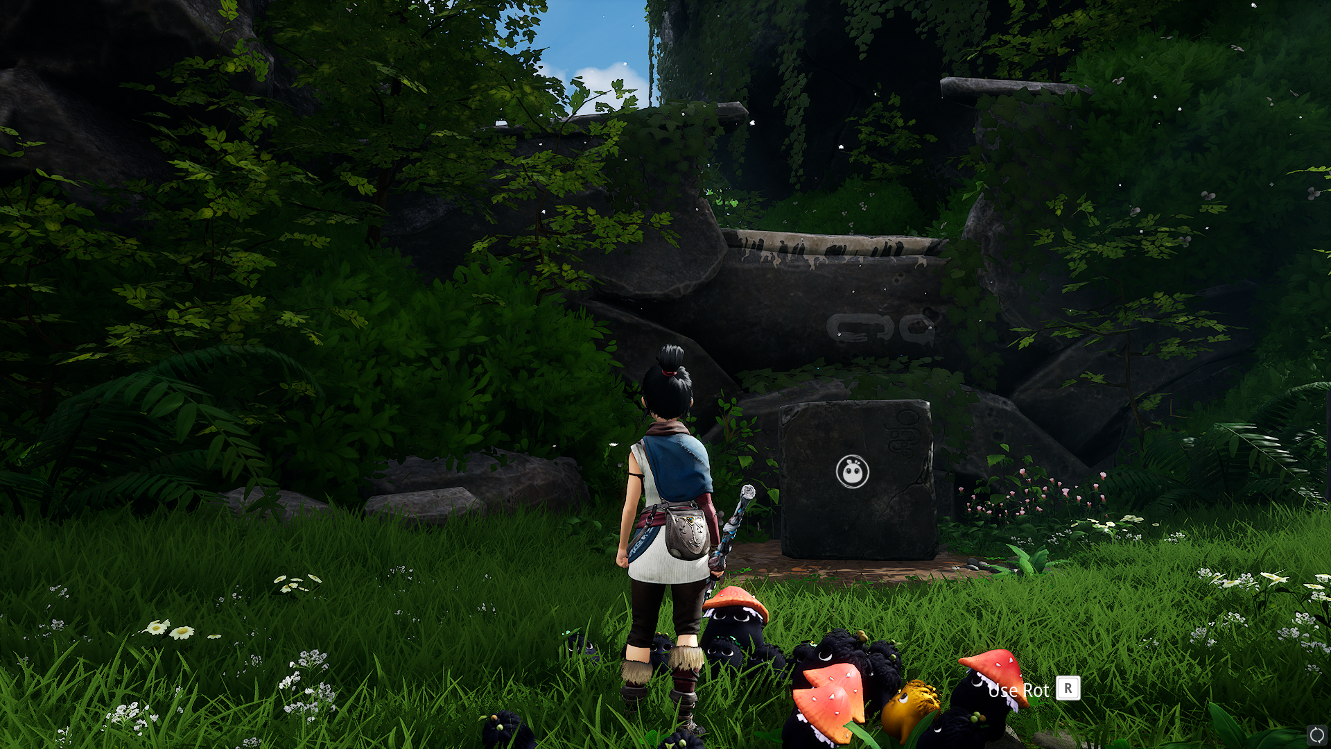 Kena standing by a cube boulder that her Rot have just moved