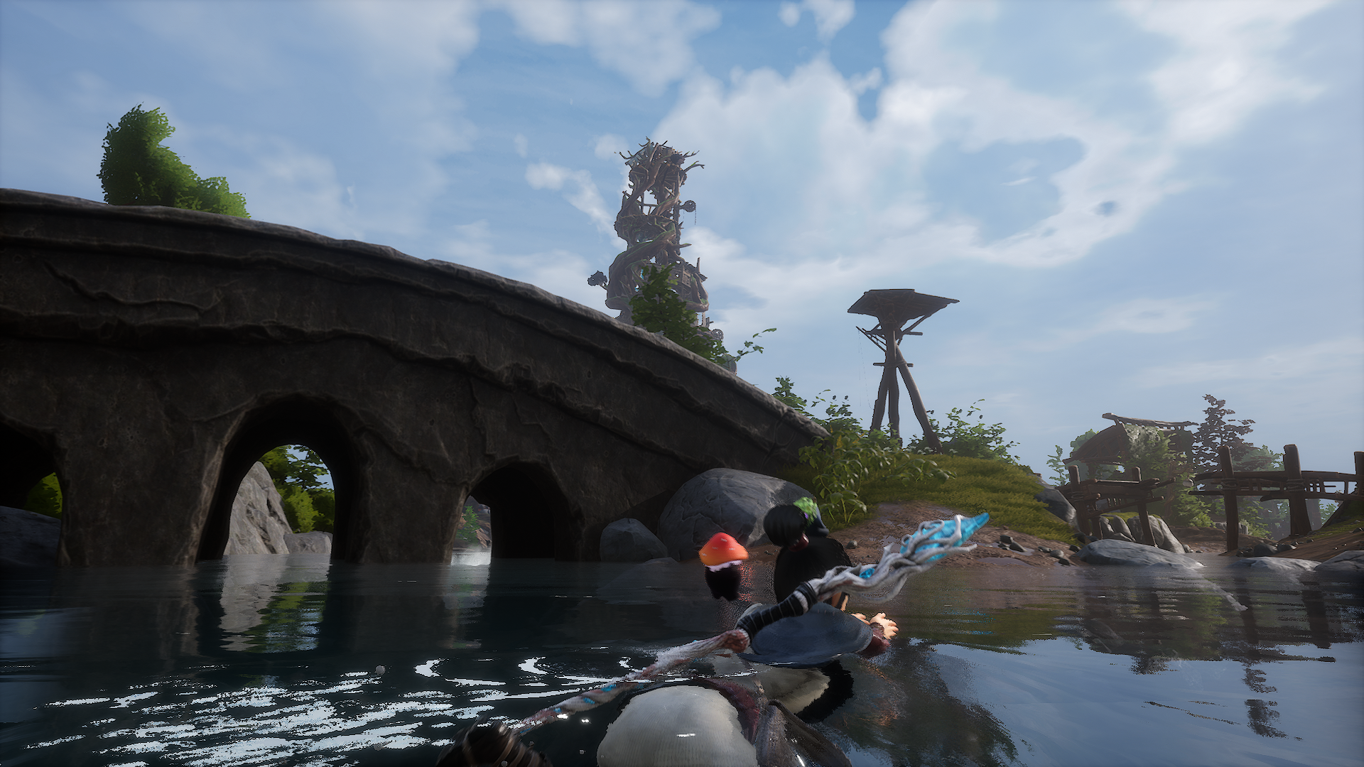 Kena swimming next to a stone bridge