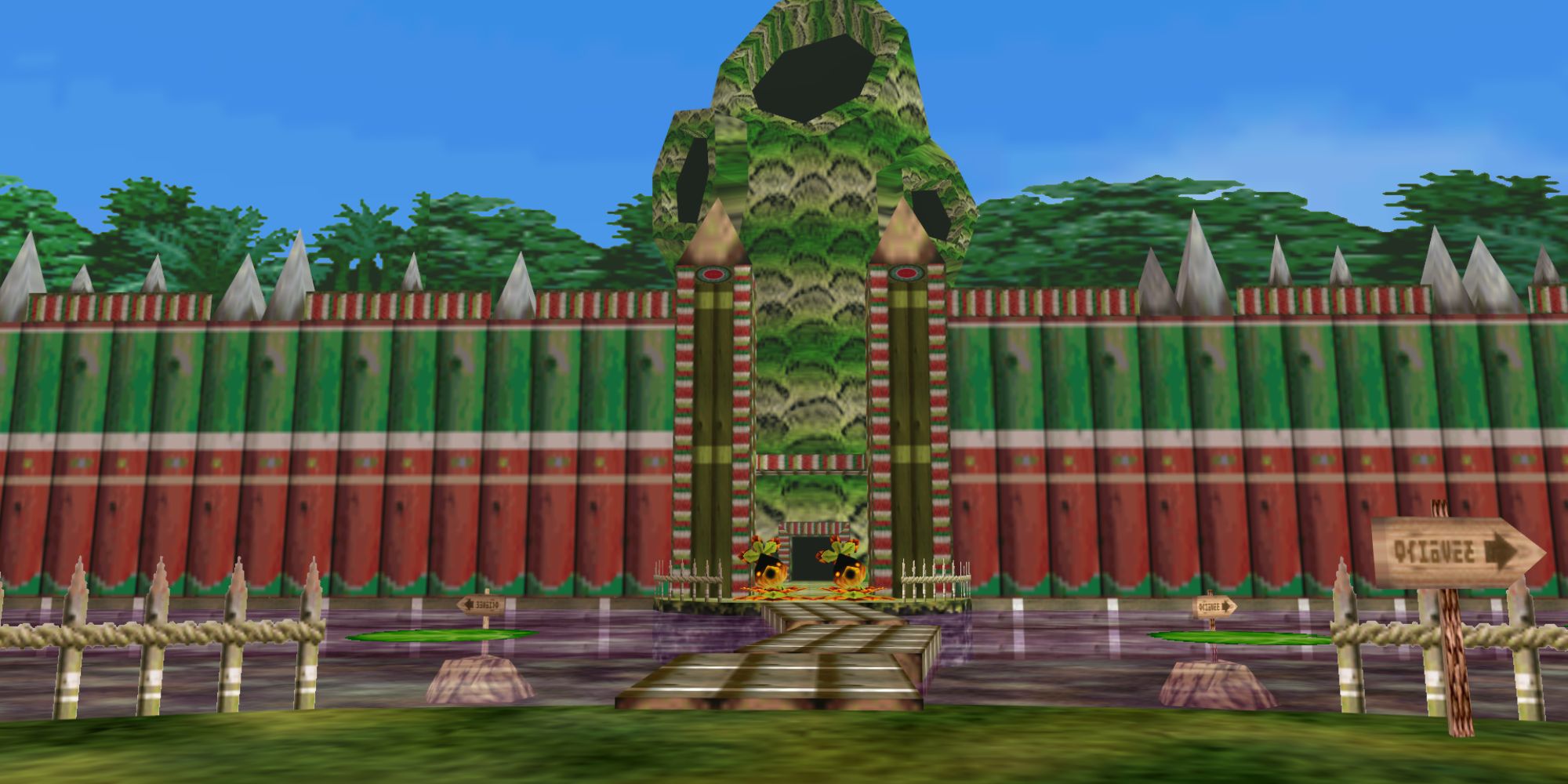 The Legend Of Zelda Locations wide shot of the entrance to Deku Palace with Deku guards seen in the distance and a narrow walkway over water in the foreground