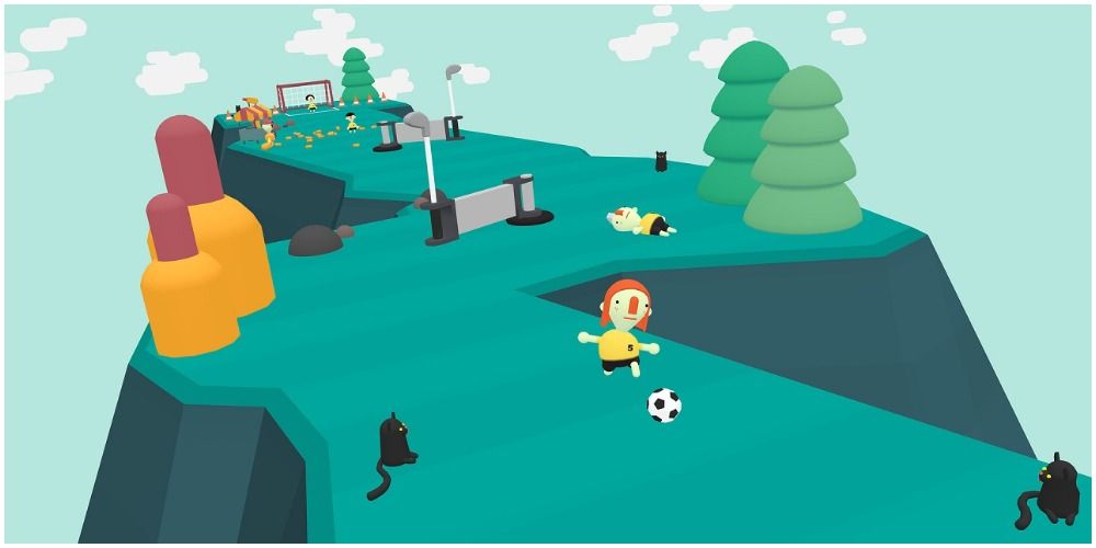 Kid on mountain with soccer ball surrounded by cats. 