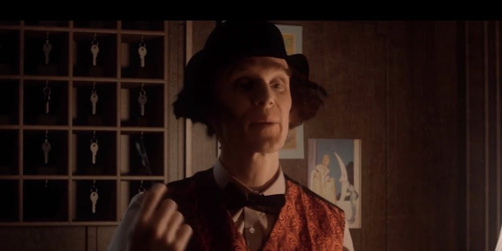 A Screenshot From At Dead Of Night Showing Jimmy In Dialogue At The Hotel Lobby