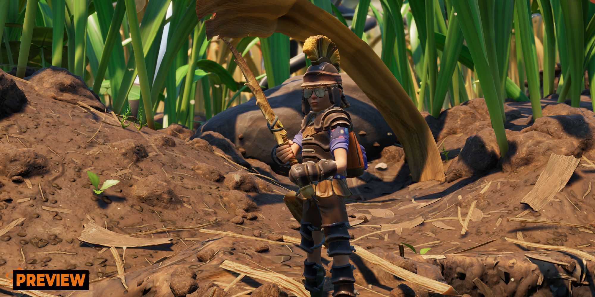 a child in grounded in roman looking armour amongst some dirt and grass.