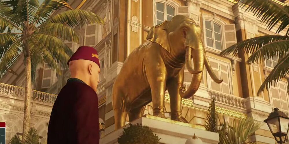 A Screenshot Of A Crying Elephant Statue From Hitman Gameplay In The Bangkok Map.
