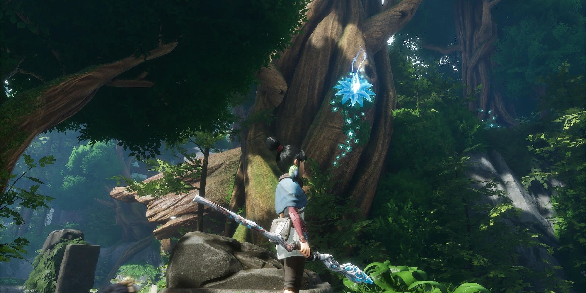 Weird Things In Kena Bridge of Spirits Kena stood holding her staff in a dense forest by a towering tree with a shining blue flower high up its trunk