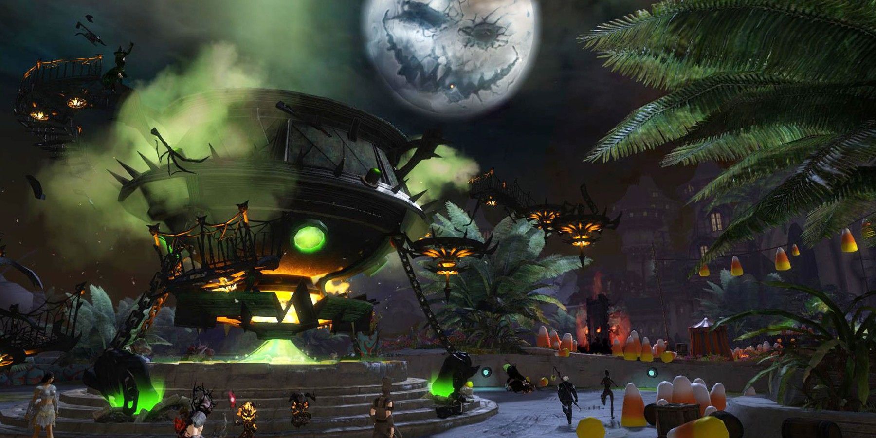 Nighttime with people in costumes and candy corn decorations.