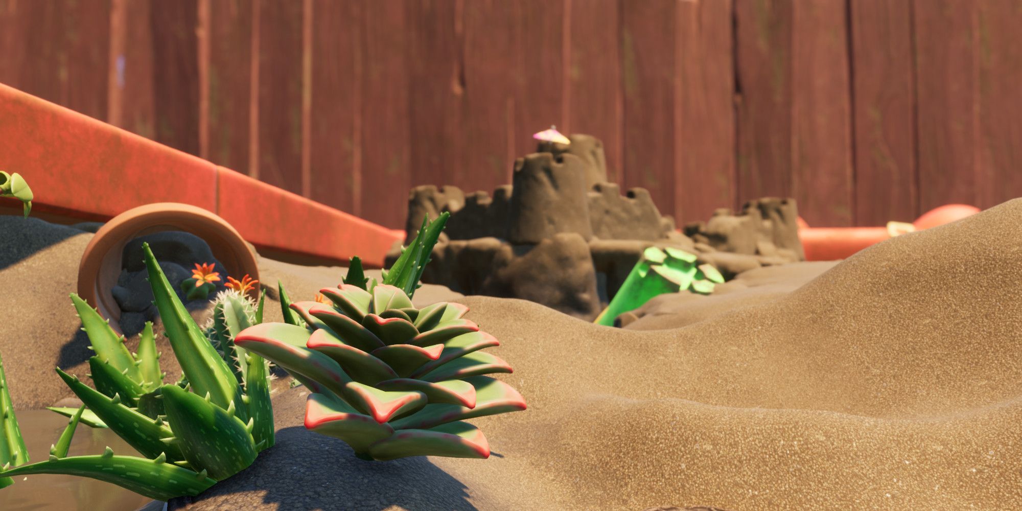 a golden sandbox with succulents in it. It looks very hot